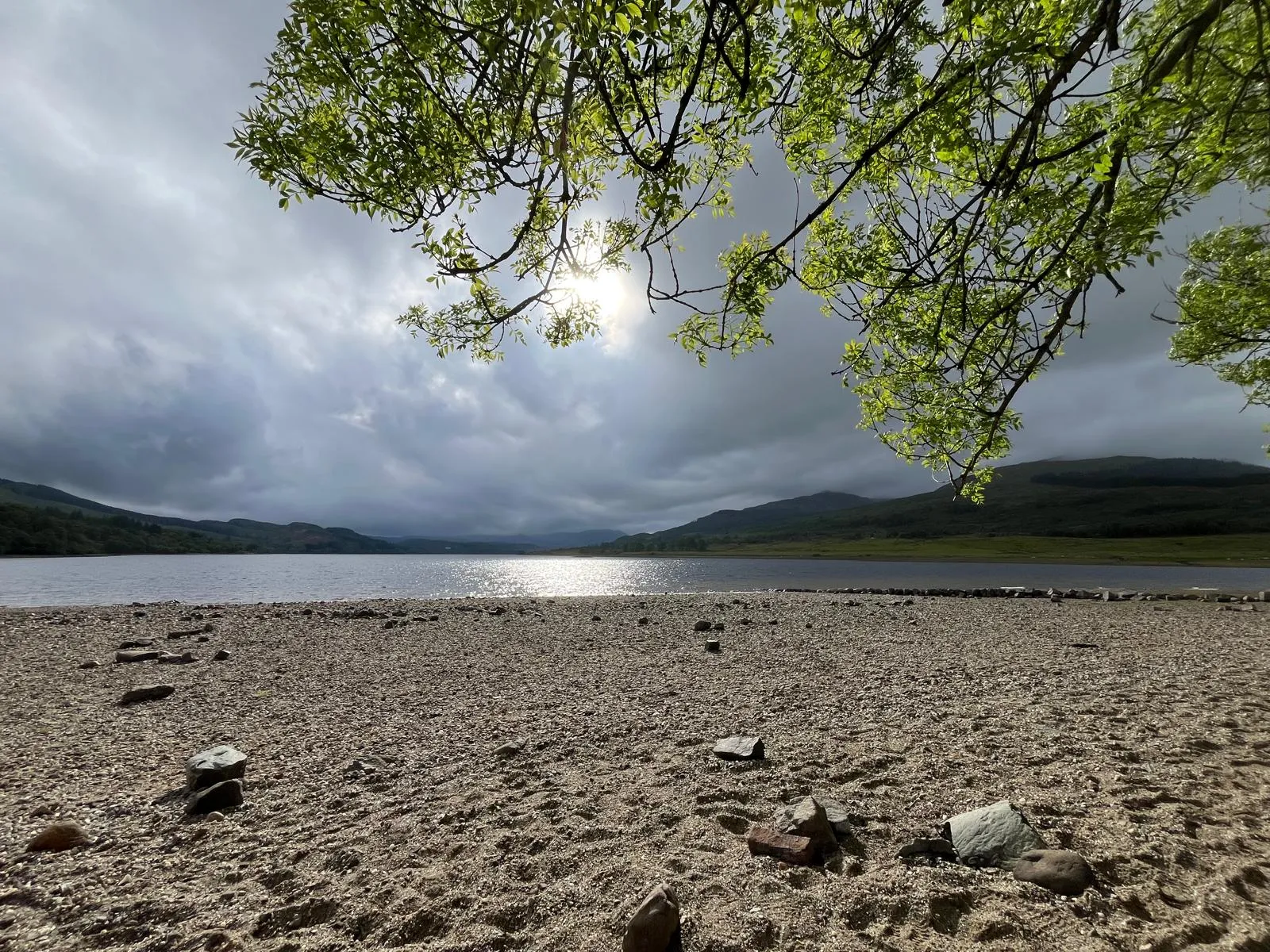 Wild swimming in a sun-lit Scottish loch